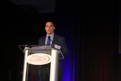 As Chair of the Goodwill and Wellness Committee, Chris Mitchell addressed the 2019 CoSIDA luncheon audience in Orlando on CoSIDA’s community service event working with Samaritan's Feet for a shoe distribution to young children at Frontline Outreach Frontline Outeach; he also gave information on the annual 5K fun run/walk and the fundraising dollars for Frontline Outreach from registration fees.